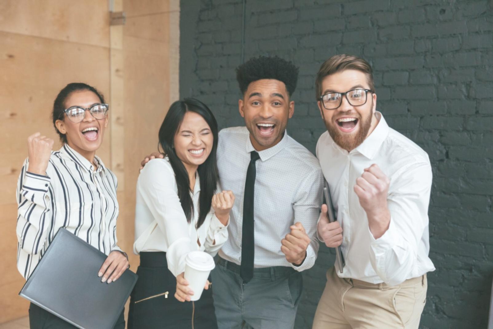 Tech startup team celebrating successful funding round