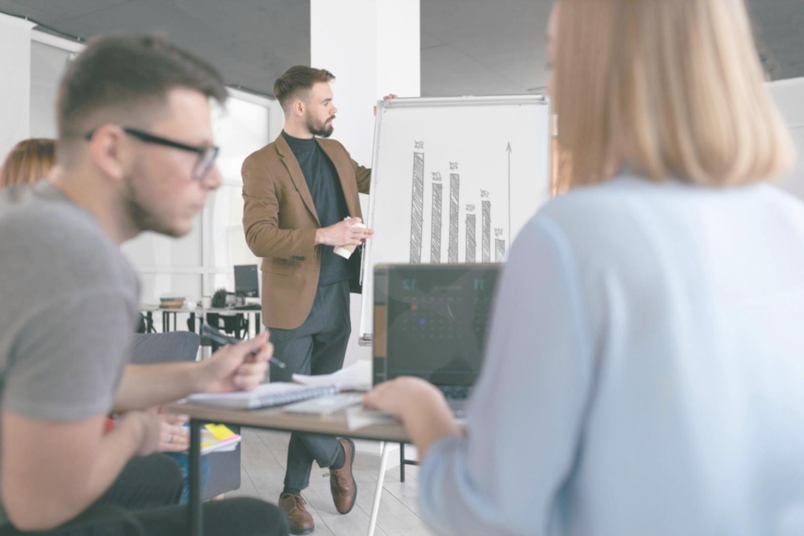 Modern business meeting with digital analytics displays showing negotiation data and market trends